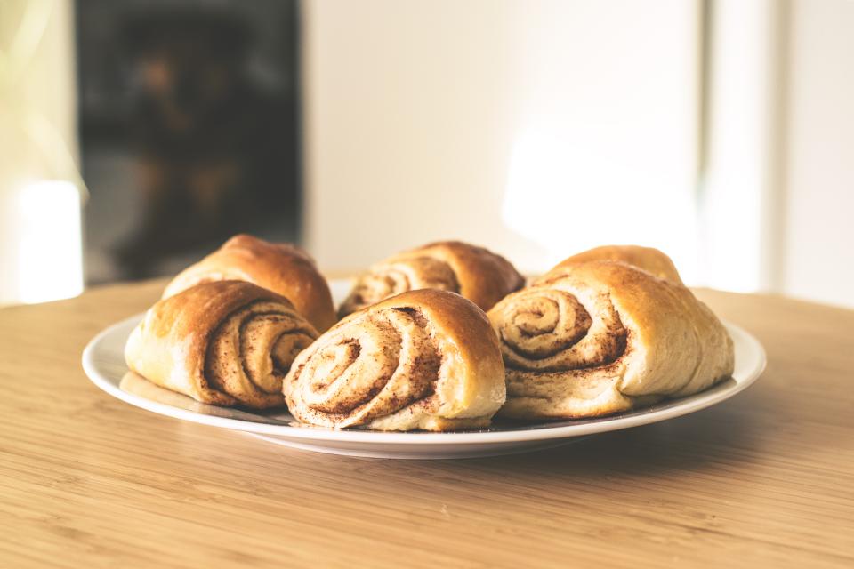 Close-up of cinnamon rolls on a baking tray.