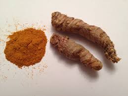 Whole turmeric root, with curry powder.